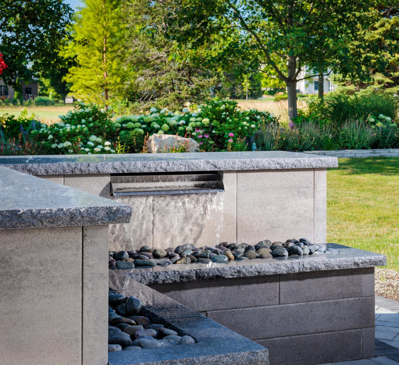 Beautiful water feature with river rock in backyard